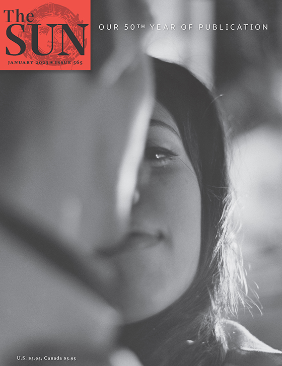 January 2023 cover of The Sun. Close-up of the side of a man’s face as he looks at a woman who is looking intently at him and smiling with her mouth closed.